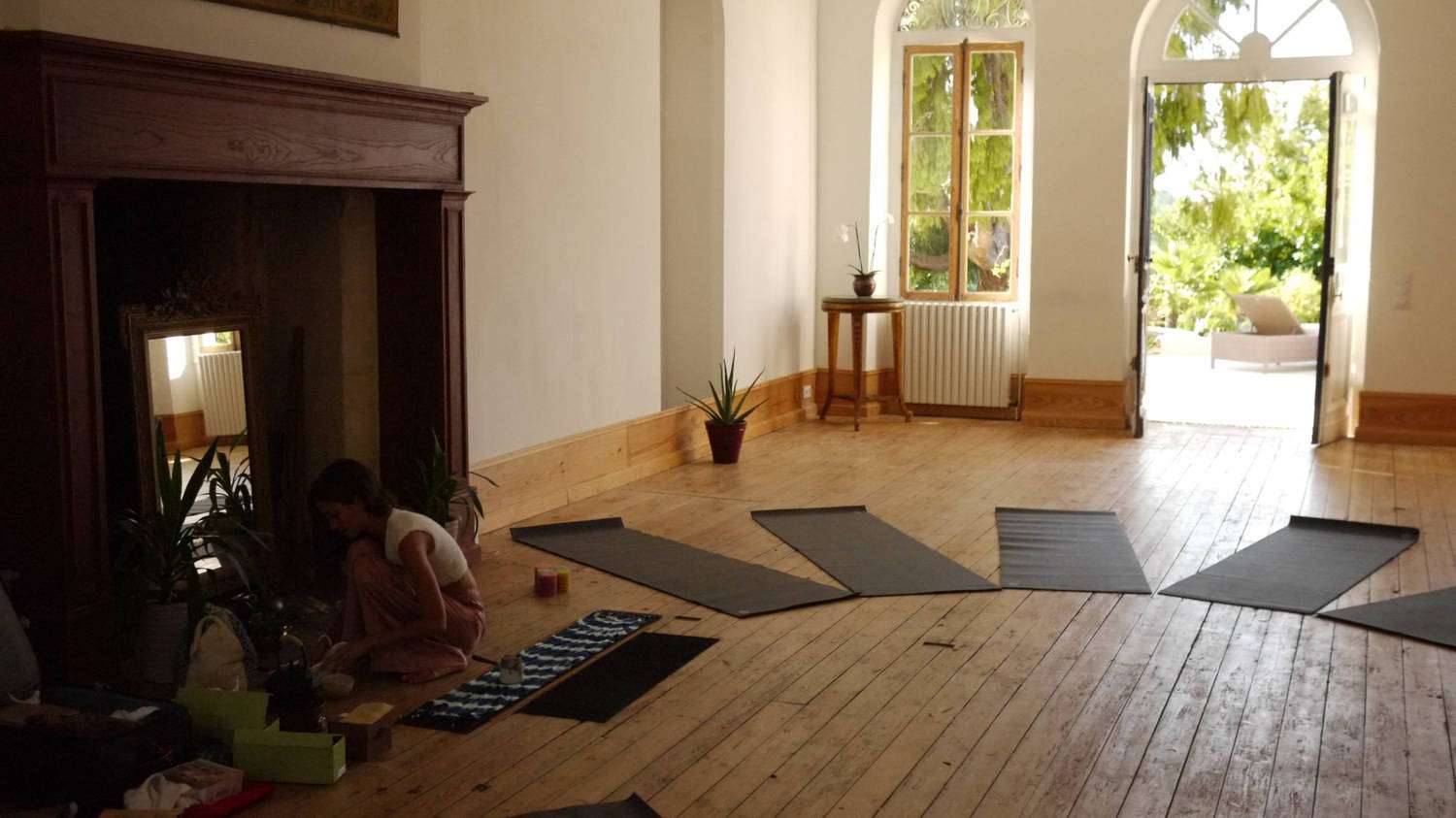 Chateau Fengari's studio set up for yoga, with mats and bolsters in a circle.
