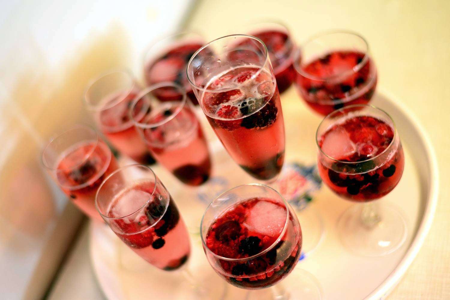 Champagne glasses filled with fruits 